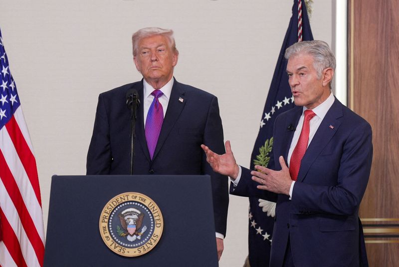 FILE PHOTO: U.S. President Donald Trump listens as Dr. Mehmet Oz, Administrator for the Centers for Medicare and Medicaid Services, speaks during an event to unveil the TrumpRx drug discount site, in the South Court Auditorium on the White House campus, in Washington, D.C., U.S., February 5, 2026. REUTERS/Al Drago/File Photo