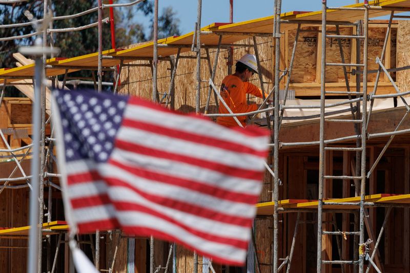 A construction worker is shown at work on a multi-unit residential housing project in Encinitas, California, U.S., July 28, 2025.   REUTERS/Mike Blake