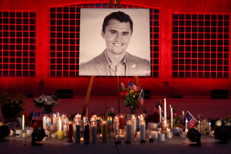 Candles and flowers are placed near an image of Charlie Kirk, during a vigil at Orem City Center Park, after U.S. right-wing activist and commentator, Charlie Kirk, an ally of U.S. President Donald Trump, was fatally shot during an event at Utah Valley University, in Orem, Utah, U.S. September 11, 2025.  REUTERS/Jim Urquhart
