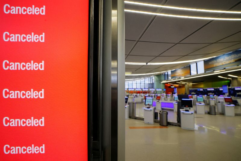 Cancelled flights are displayed on a board at Logan International Airport during a winter blizzard snow storm in Boston, Massachusetts, U.S., February 23, 2026.   REUTERS/Brian Snyder/File Photo