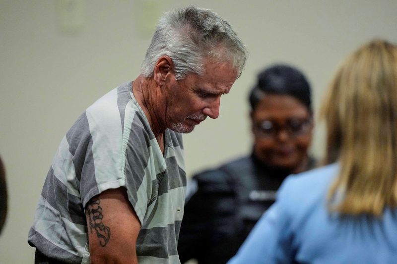 Colin Gray, 54, the father of Apalachee High School shooter Colt Gray, 14, who is charged as an adult with four counts of murder in the deaths of Mason Schermerhorn and Christian Angulo, both 14, Richard Aspinwall, 39, and Cristina Irimie, 53, enters the Barrow County courthouse for his first appearance, in Winder, U.S., September 6, 2024.  Brynn Anderson/Pool via REUTERS