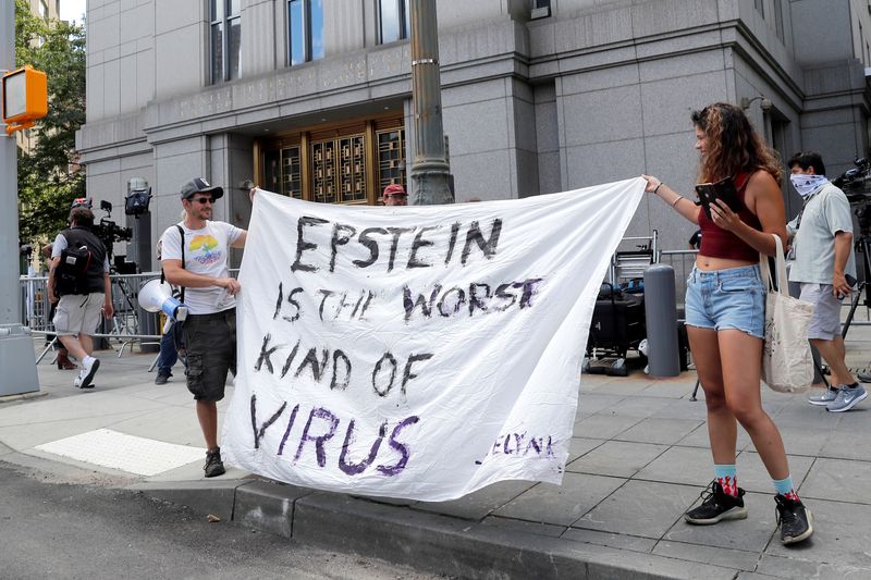 Protesters and members of the news media gather outside Manhattan Federal Court, during the arraignment hearing of Ghislaine Maxwell for her role in the sexual exploitation and abuse of minor girls by Jeffrey Epstein, in the Manhattan borough of New York City, New York, U.S. July 14, 2020. REUTERS/Mike Segar