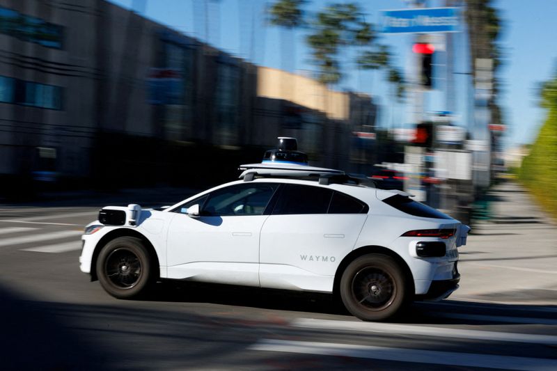 FILE PHOTO: A Waymo driverless taxi is shown driving in Hollywood, Los Angeles, California, U.S., January 13, 2026.  REUTERS/Mike Blake/File Photo