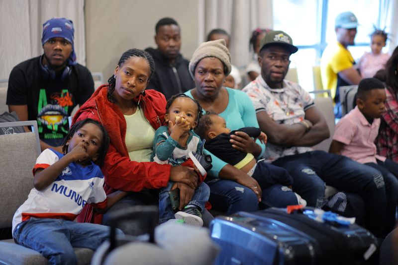 Immigrants from Haiti who recently arrived in Boston from other parts of the United States listen to instructions from representatives of La Colaborativa, a non-profit community services organization based in Chelsea, as they arrive at temporary housing in a hotel in Everett, Massachusetts, U.S., July 10, 2023.     REUTERS/Brian Snyder/File Photo