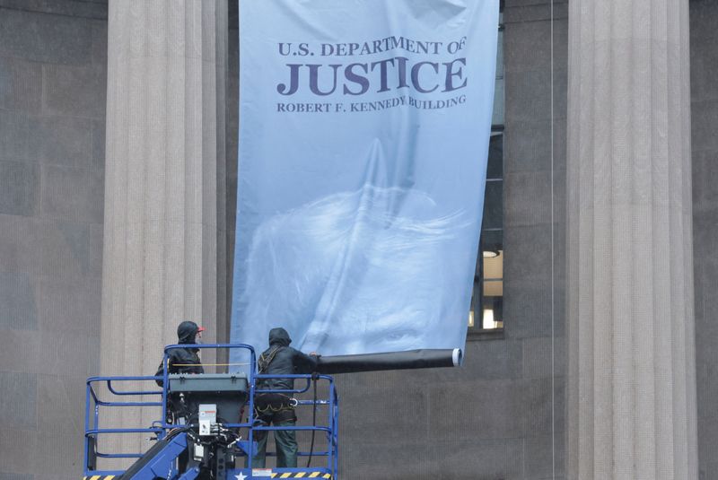 A new banner depicting U.S. President Donald Trump is hung on the Department of Justice building in Washington, D.C., U.S., February 19, 2026. REUTERS/Jonathan Ernst