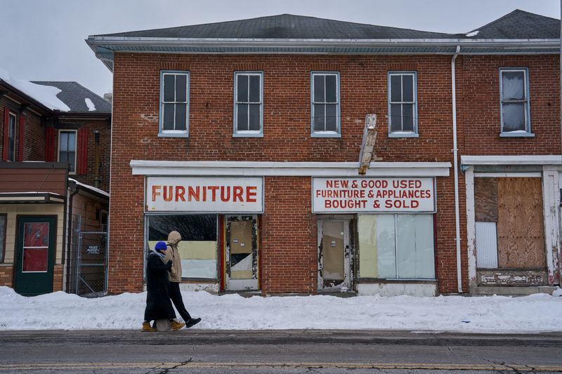 Pedestrians walk past a derelict furniture store in Springfield, Ohio, U.S., February 4, 2026. REUTERS/Bing Guan