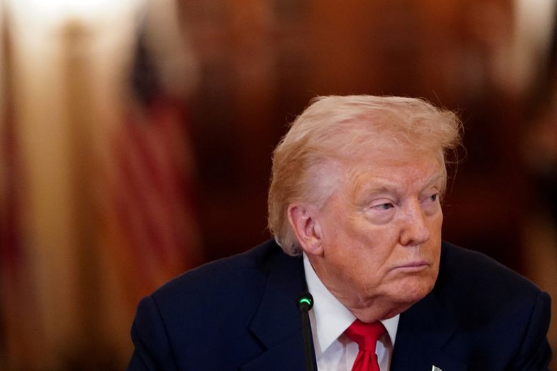 FILE PHOTO: U.S. President Donald Trump looks on during a round table on collegiate sports in the White House in Washington, D.C., March 6, 2026. REUTERS/Nathan Howard/File Photo