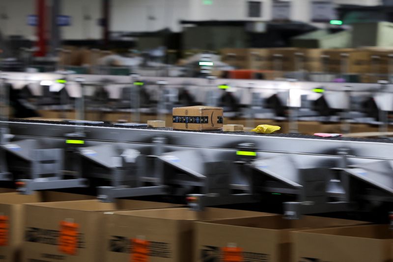An Amazon package moves along on a conveyor belt at the United States Postal Service (USPS) Processing & Distribution Center in Los Angeles, California, U.S., December 2, 2025. REUTERS/Daniel Cole