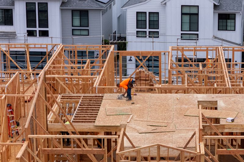 FILE PHOTO: A drone view shows a construction worker performing tasks on a multi-home residential project by Shea Homes in Encinitas, California, U.S. July 21, 2025.  REUTERS/Mike Blake/File Photo