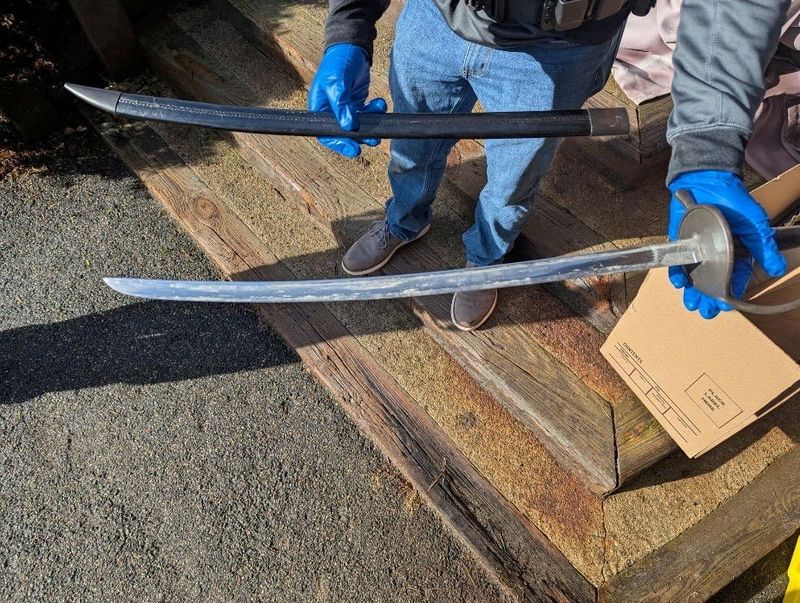 A law enforcement agent holds one of several bladed weapons seized by authorities after the arrest of Andrew Emerald in Great Barrington, Massachusetts, U.S., April 1, 2026, on charges that he threatened U.S. President Donald Trump in Facebook posts. U.S. Attorney's Office for the District of Massachusetts/Handout via REUTERS