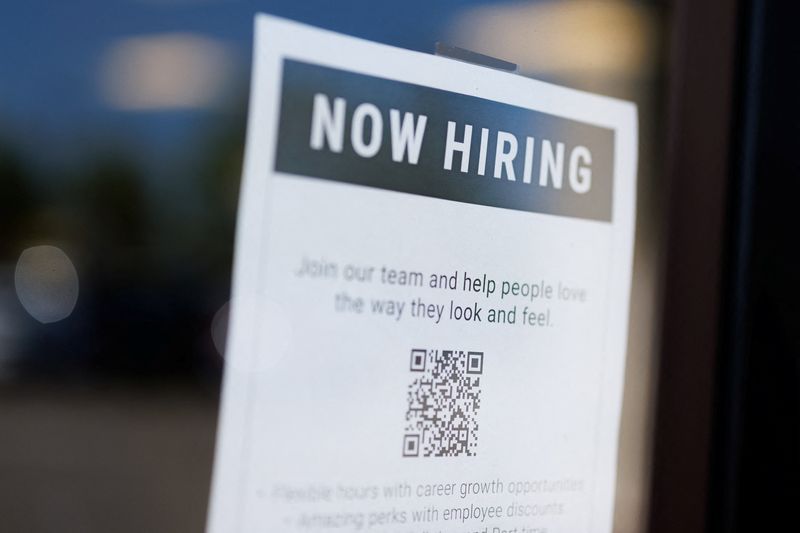 A "now hiring" sign is displayed on a local business after, U.S. employment growth slowed more than expected in July, in Encinitas, California, U.S. August 1, 2025. REUTERS/Mike Blake/File Photo