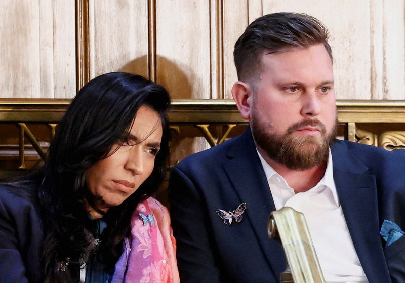 Sky and Amanda Roberts, the brother and sister-in-law of the late Virginia Roberts Giuffre, a survivor of Jeffrey Epstein’s international trafficking ring, react as U.S. President Donald Trump delivers the State of the Union address in the House Chamber of the U.S. Capitol in Washington, D.C., U.S., February 24, 2026.  REUTERS/KEVIN LAMARQUE