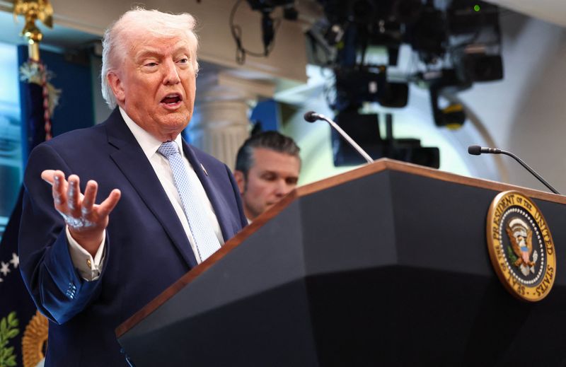 U.S. President Donald Trump, flanked by Secretary of Defense Pete Hegseth, speaks during a press conference in the James S. Brady Press Briefing Room at the White House in Washington, D.C., U.S., April 6, 2026. REUTERS/Kevin Lamarque