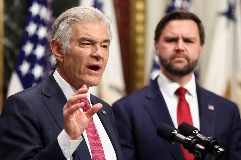 FILE PHOTO: Administrator for the Centers for Medicare & Medicaid Services Mehmet Oz speaks next to U.S. Vice President JD Vance about combating fraud, at the Eisenhower Executive Office Building, in Washington D.C., U.S, February 25, 2026.  REUTERS/Kevin Lamarque/File Photo