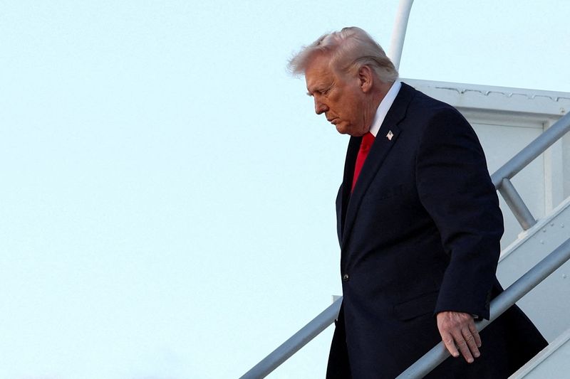 FILE PHOTO: U.S. President Donald Trump exits Air Force One as he arrives at Miami International Airport in Florida, U.S., April 11, 2026. REUTERS/Kevin Lamarque/File Photo