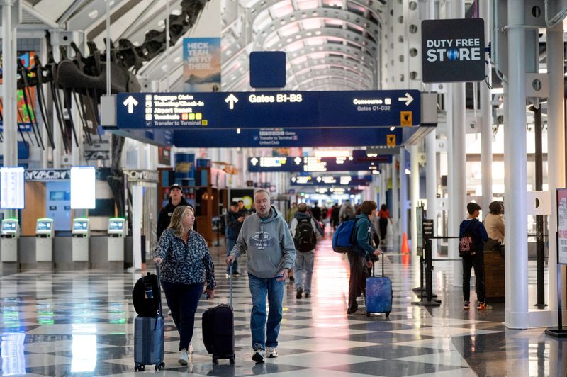 FILE PHOTO: Travelers walk through Chicago O'Hare International Airport during the week of Thanksgiving in Chicago, Illinois, U.S. November 27, 2024.  REUTERS/Vincent Alban//File Photo