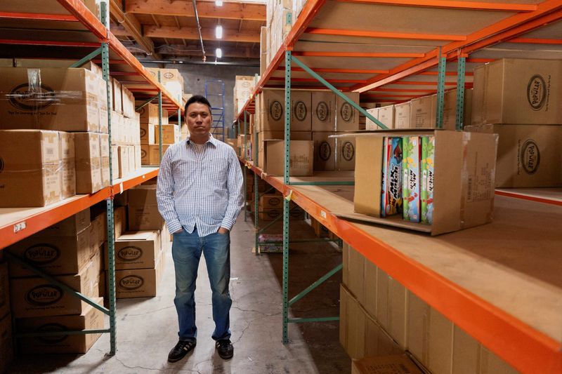 FILE PHOTO: CEO Jason Cheung of toy manufacturer Huntar Company Inc poses amongst partially empty shelves at the U.S. office in Union City, California, U.S. May 8, 2025.  REUTERS/Brittany Hosea-Small/File Photo