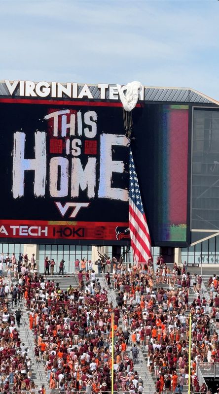 A Parachuter gets stuck on the scoreboard at Virginia Tech's spring game after strong winds pushed the parachute off its landing path, in Blacksburg, Virginia, U.S., April 18, 2026 in this screengrab taken from a social media video. Charlz Chalmers/via REUTERS
