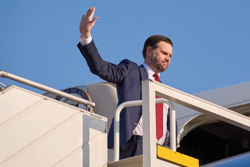 FILE PHOTO: U.S. Vice President JD Vance gestures as he boards Air Force Two, after peace talks with Iran in Islamabad, Pakistan, Sunday, April 12, 2026. Jacquelyn Martin/Pool via REUTERS/File Photo