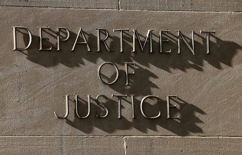 FILE PHOTO: A sign for the U.S. Department of Justice in Washington, D.C., April 6, 2026. REUTERS/Kevin Lamarque/File Photo