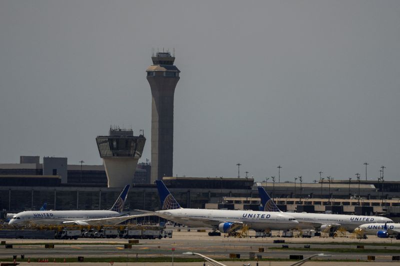 The control tower is pictured as planes are seen on the tarmac at Newark International Airport in Newark, New Jersey, U.S., May 11, 2025. REUTERS/Eduardo Munoz