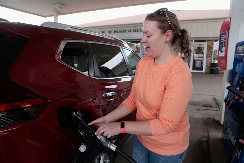Katie Crist pumps gas into her vehicle at a gas station in Charlotte, Michigan, U.S., April 17, 2026.  REUTERS/Rebecca Cook