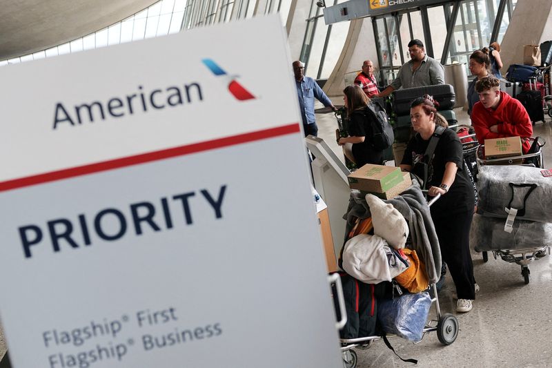 FILE PHOTO: People from the first group of white South Africans granted refugee status for being deemed victims of racial discrimination under U.S. President Trump's Refugee plan, check in for a connecting flight, at Dulles International Airport, in Dulles, Virginia, U.S., May 12, 2025. REUTERS/Jonathan Ernst/File Photo