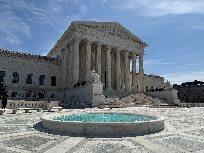 FILE PHOTO: A person stands near the U.S. Supreme Court building in Washington, D.C., U.S., March 14, 2026. REUTERS/Will Dunham/File Photo