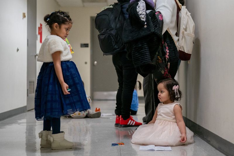 Children play as their guardians wait to be check into court hearings at U.S. immigration court in Manhattan, in New York City, U.S., January 13, 2026. REUTERS/David 'Dee' Delgado