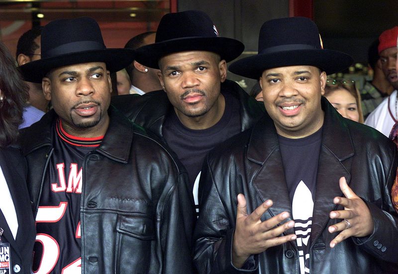 FILE PHOTO: Members of the musical group RUN-DMC (L to R) Jason Mizell (Jam Master Jay), Darryl McDaniels (DMC) and Joseph Simmons (DJ Run) pose for photographs after being inducted into Hollywood's Rockwalk, in Los Angeles, California, U.S., on February 25, 2002. Hollywood's Rockwalk is a sidewalk gallery dedicated to honoring artists who have made a significant contribution to the evolution of rock 'n roll. REUTERS/Adrees Latif/File Photo