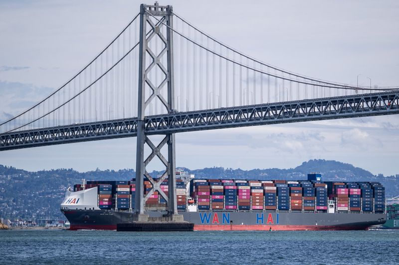 A container ship passes under the San Francisco-Oakland Bay Bridge, in San Francisco, California, U.S., April 9, 2026. REUTERS/Carlos Barria