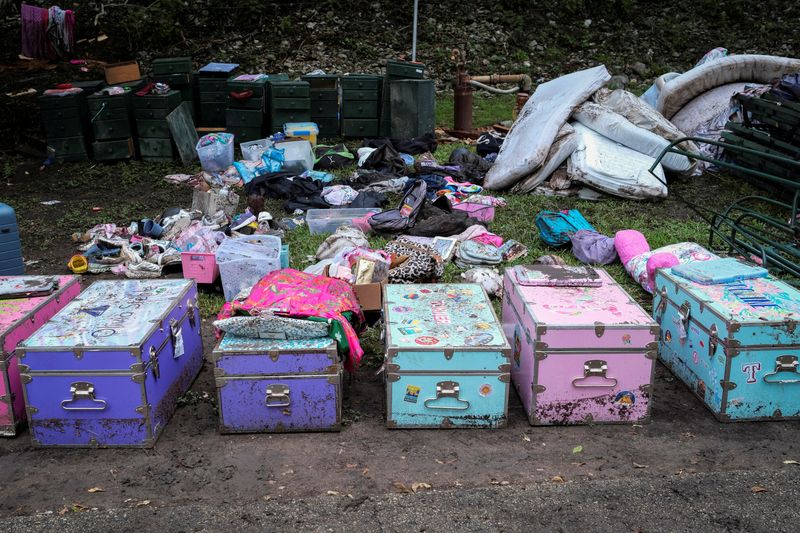 FILE PHOTO: Campists' belongings lie on the ground following flooding on the Guadalupe River, at Camp Mystic, Hunt, Texas, U.S. July 7, 2025. REUTERS/Marco Bello/File Photo