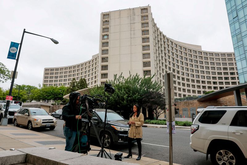 FILE PHOTO: Members of the media work near the Washington Hilton hotel, where a shooting incident at the annual White House Correspondents' Association dinner, in Washington, D.C., U.S., April 26, 2026. REUTERS/Kylie Cooper/File Photo