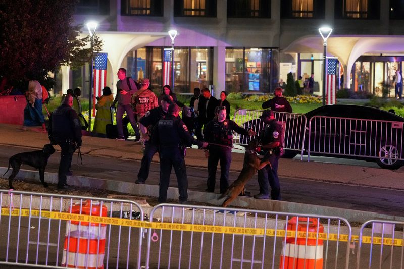Police K-9 Unit officers stand with other law enforcement personnel at the venue following a shooting incident during the annual White House Correspondents' Association dinner, in Washington, D.C., U.S., April 25, 2026. REUTERS/Ken Cedeno/File Photo
