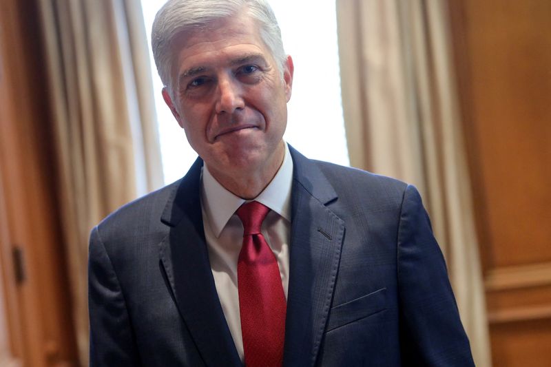 FILE PHOTO: U.S. Supreme Court Justice Neil Gorsuch poses for a picture in his chambers at the Supreme Court building in Washington, U.S. September 13, 2019.  REUTERS/Jonathan Ernst/File Photo