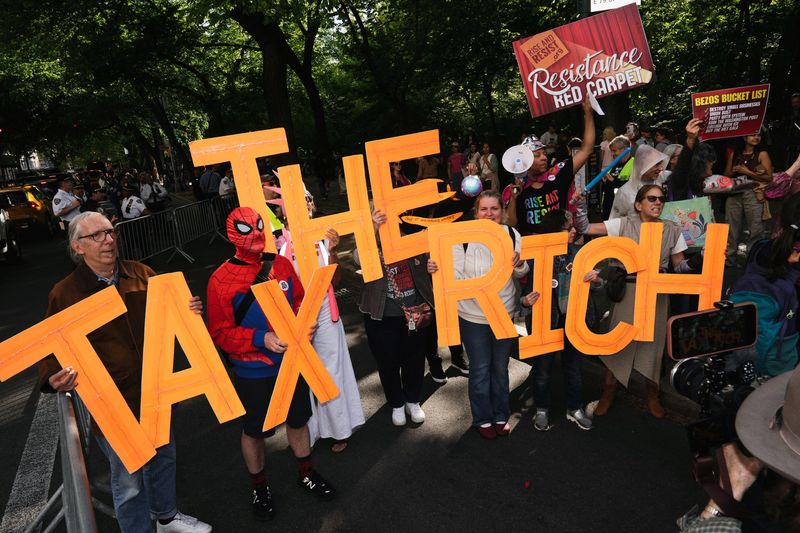 Demonstrators participate in a “Resistance Red Carpet” protest against the Met Gala, the star-studded fundraiser known for its extravagant fashion and high-profile guests, in New York City, U.S., May 4, 2026. REUTERS/Bing Guan