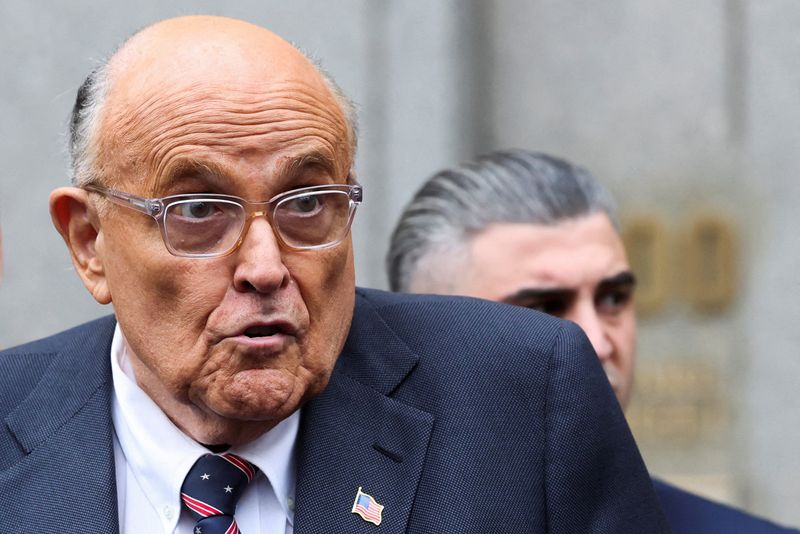 FILE PHOTO: Former Donald Trump lawyer and former New York City Mayor Rudolph Giuliani speaks to the media as he departs the U.S. Federal court following a hearing in his case to surrender valuables to Georgia election workers he was found to have defamed, in New York City, U.S., November 26, 2024. REUTERS/Brendan McDermid/File Photo