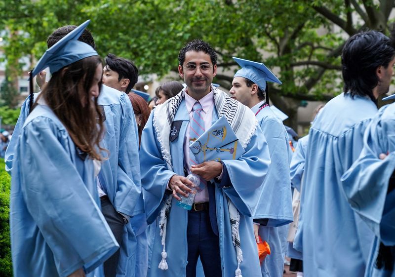 FILE PHOTO: Columbia University student Mohsen Mahdawi stands with other students during the university's commencement ceremony on its main campus, in Manhattan, New York City, U.S., May 21, 2025. REUTERS/Ryan Murphy/ File Photo