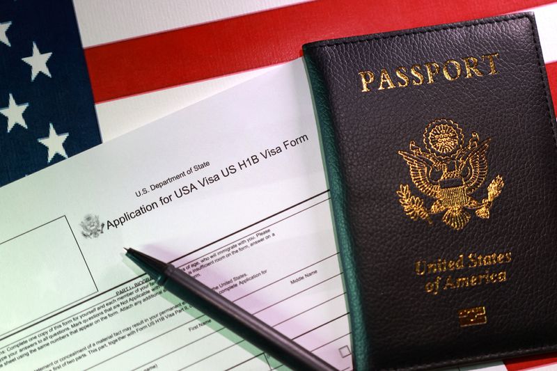 A U.S. flag, a passport and a U.S. H-1B Visa application form are seen in this illustration taken, September 22, 2025. REUTERS/Dado Ruvic/Illustration