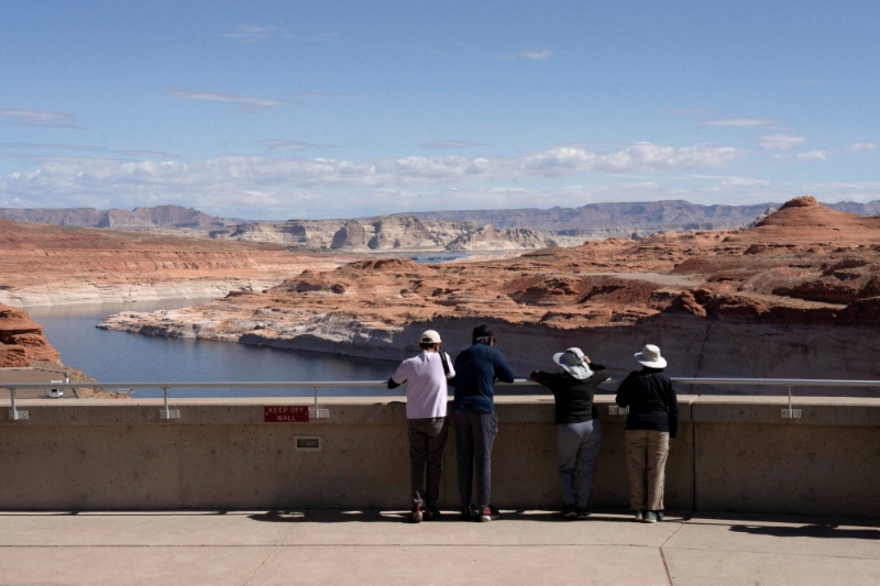 FILE PHOTO: Tourists look at the Colorado River from Glen Canyon Dam near Page, Arizona, U.S., May 15, 2025.  REUTERS/Rebecca Noble/File Photo