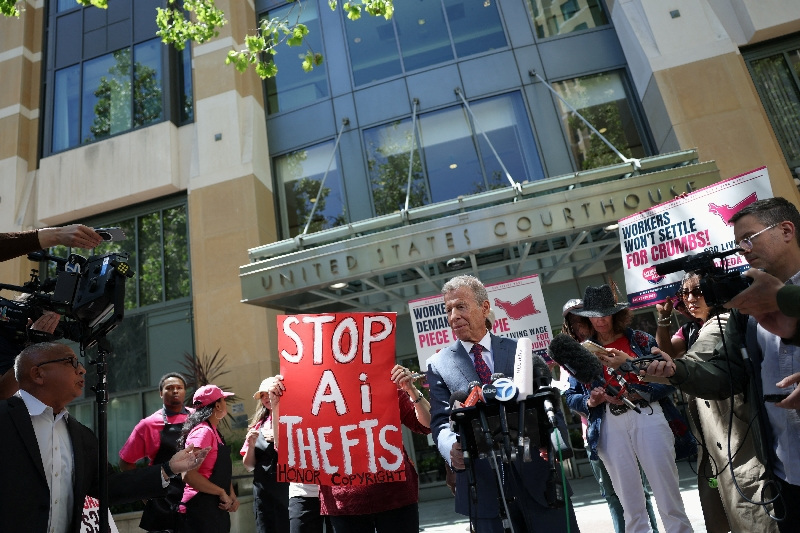 Elon Musk's attorney Marc Toberoff speaks to the press as demonstrators hold placards outside the federal courthouse, as the trial in Elon Musk's lawsuit over OpenAI's for-profit conversion continues, in Oakland, California, U.S., May 18, 2026. REUTERS/Manuel Orbegozo