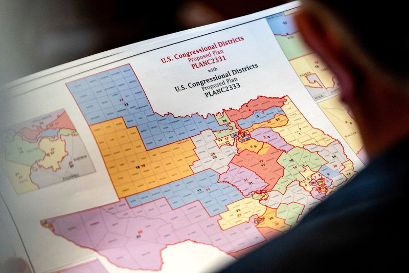 FILE PHOTO: State Representative Matt Morgan (R-TX) holds a map of the new proposed congressional districts in Texas, during a legislative session as Democratic lawmakers, who left the state to deny Republicans the opportunity to redraw the state's 38 congressional districts, begin returning to the Texas State Capitol in Austin, Texas, U.S. August 20, 2025. REUTERS/Sergio Flores/File Photo
