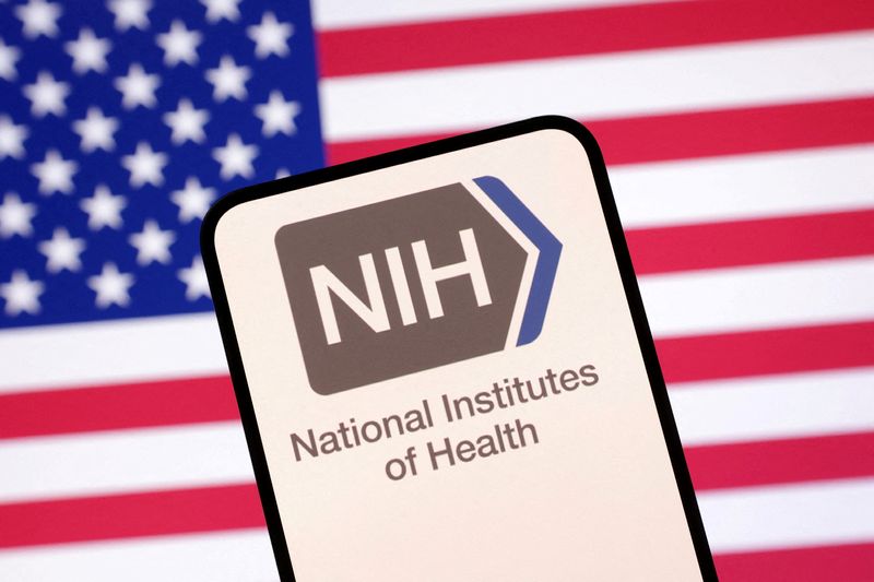 FILE PHOTO: United States National Institutes of Health logo and U.S. flag are seen in this illustration taken April 23, 2025. REUTERS/Dado Ruvic/Illustration/File Photo