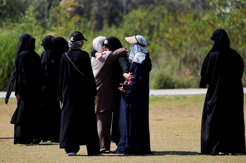 People embrace as they arrive at a prayer service for the victims of a shooting at the Islamic Centre, in San Diego, California, U.S., May 21, 2026.  REUTERS/Mike Blake
