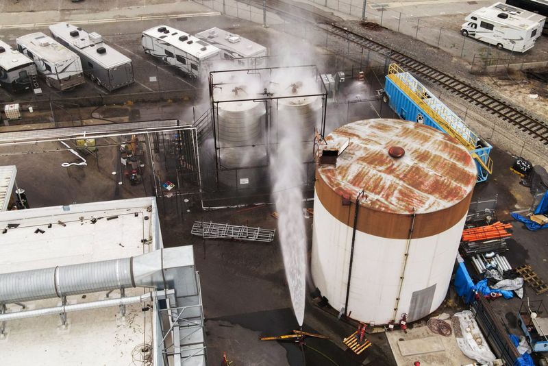 A drone view shows water being sprayed during a chemical incident involving a leaking tank of methyl methacrylate, a flammable liquid used in the aerospace industry, forcing an evacuation in the surrounding area, in Garden Grove, California, U.S., May 23, 2026. REUTERS/David Swanson