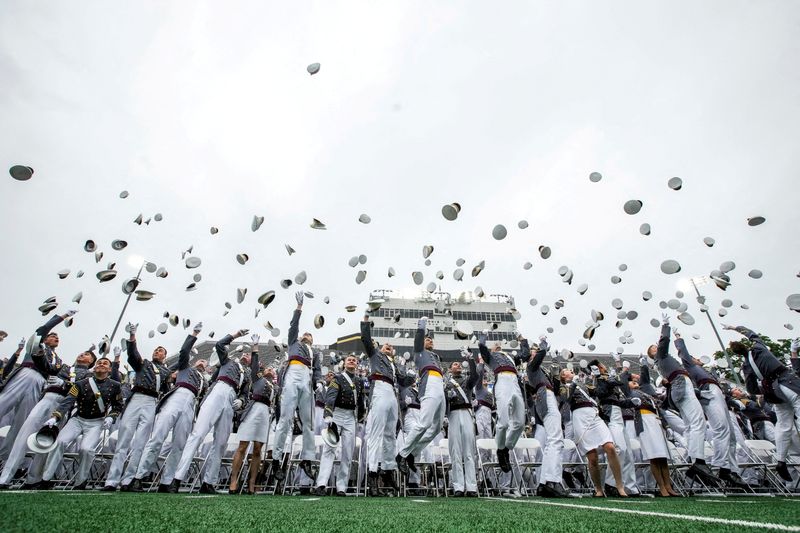 FILE PHOTO: Cadets throw their hats in the air during the commencement ceremony for the U.S. Military Academy (USMA) at West Point, New York, U.S., May 23, 2026. REUTERS/Eduardo Munoz/File Photo