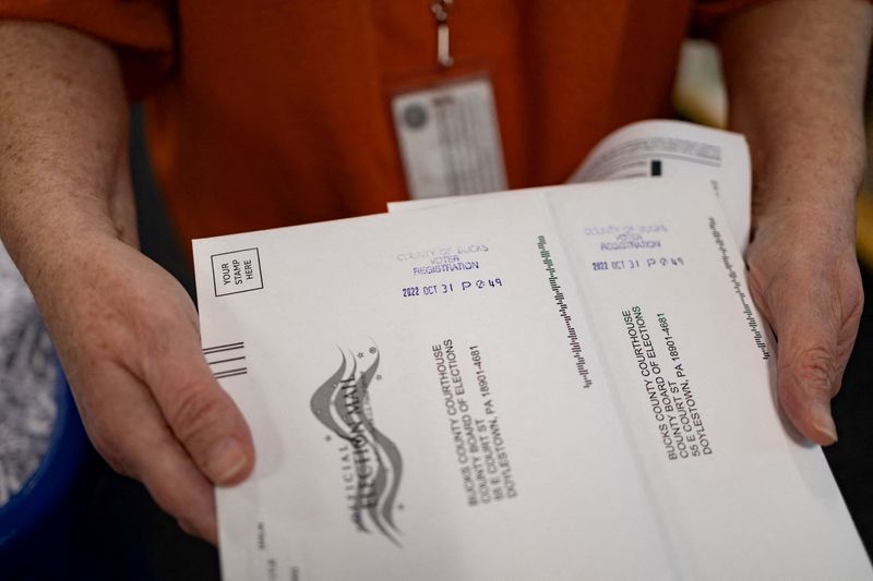FILE PHOTO: "On Demand" absentee or mail-in ballots are time stamped after being filled out in Doylestown, Pennsylvania, U.S. October 31, 2022. REUTERS/Hannah Beier