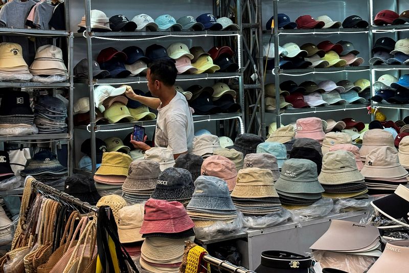 A man shops at Ninh Hiep market, classified by the U.S. Trade Representative among "notorious markets" for counterfeiting, despite government crackdowns and the threat of U.S. tariffs over the issue, on the outskirts of Hanoi, Vietnam, May 25, 2026. Picture taken with a mobile phone. REUTERS/Francesco Guarascio
