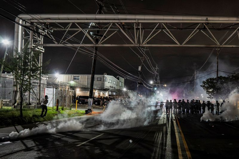 New Jersey State Policemen stand guard near the deployed tear gas as protestors remain gathered outside Delaney Hall detention center, in Newark, New Jersey, U.S., May 29, 2026. REUTERS/David Delgado