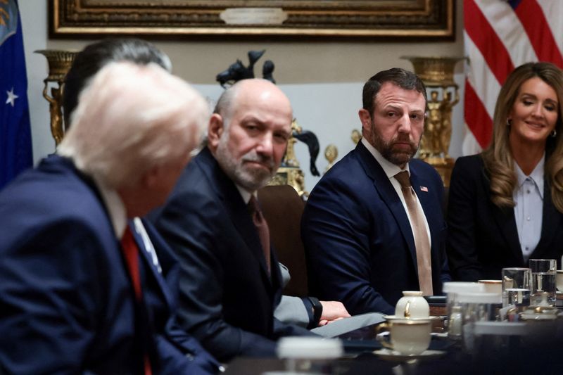 FILE PHOTO: U.S. President Donald Trump, Commerce Secretary Howard Lutnick, Secretary of Homeland Security Markwayne Mullin, and Small Business Administration Administrator Kelly Loeffler attend a cabinet meeting at the White House in Washington, D.C., U.S., March 26, 2026. REUTERS/Evelyn Hockstein/File Photo